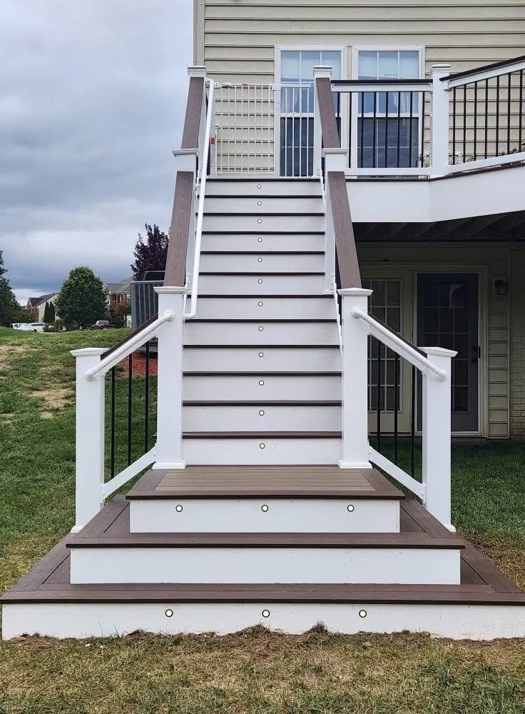 Wide composite staircase with lights set into each riser at dusk
